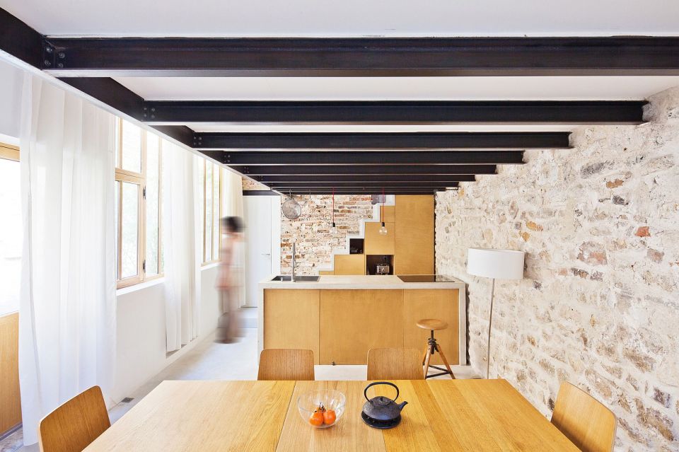 A dingy workshop in Paris was transformed into this bright and airy home with a glass-enclosed loft. | www.facebook.com/SmallHouseBliss