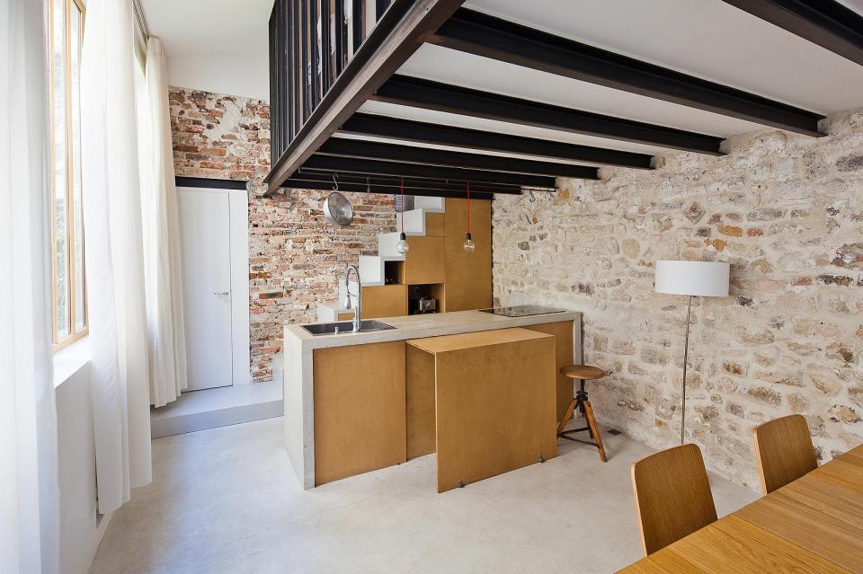 A dingy workshop in Paris was transformed into this bright and airy home with a glass-enclosed loft. | www.facebook.com/SmallHouseBliss