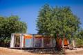 Nomad Living, a shipping container guest house that expands out to a shaded terrace. | www.facebook.com/SmallHouseBliss