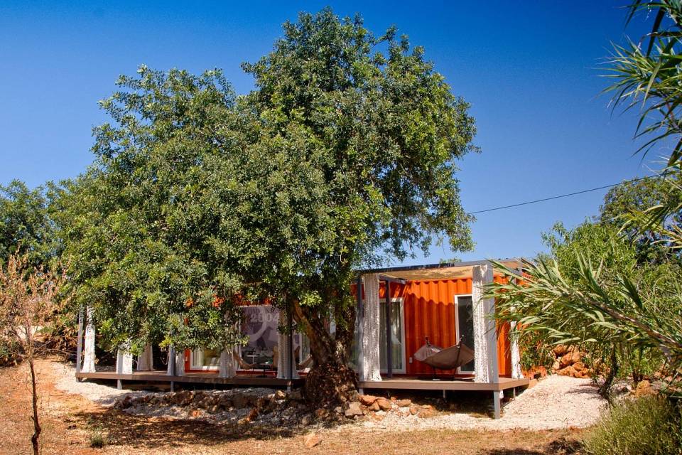 Nomad Living, a shipping container guest house that expands out to a shaded terrace. | www.facebook.com/SmallHouseBliss