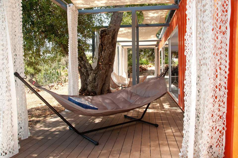 Nomad Living, a shipping container guest house that expands out to a shaded terrace. | www.facebook.com/SmallHouseBliss