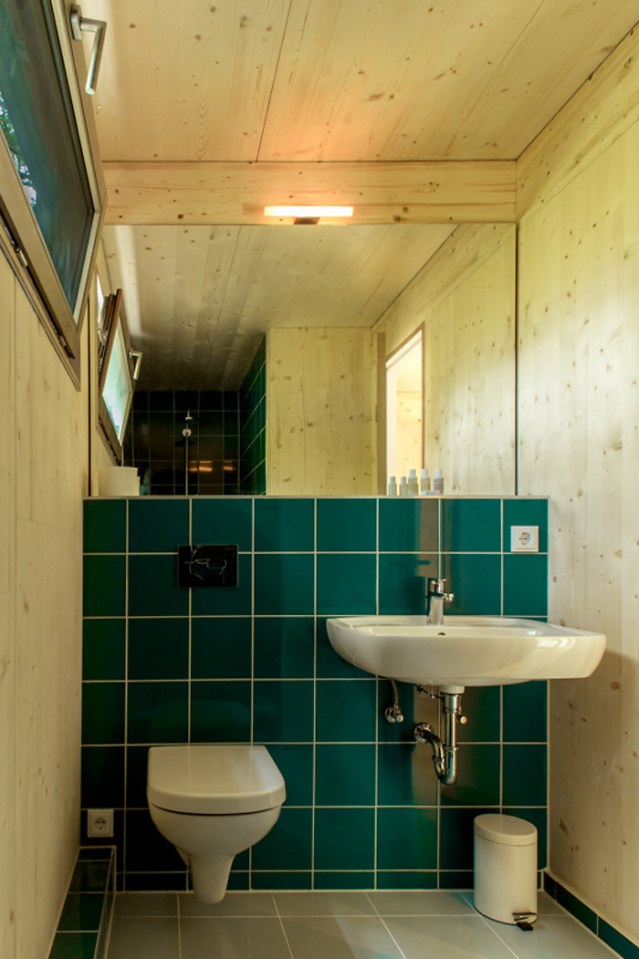 A pair of modern treehouses at the edge of a forest provide leafy retreats complete with kitchenette and bath. | www.facebook.com/SmallHouseBliss