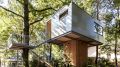 A pair of modern treehouses at the edge of a forest provide leafy retreats complete with kitchenette and bath. | www.facebook.com/SmallHouseBliss
