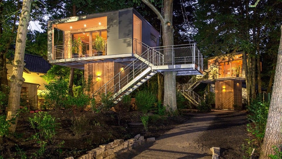 A pair of modern treehouses at the edge of a forest provide leafy retreats complete with kitchenette and bath. | www.facebook.com/SmallHouseBliss