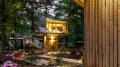 A pair of modern treehouses at the edge of a forest provide leafy retreats complete with kitchenette and bath. | www.facebook.com/SmallHouseBliss