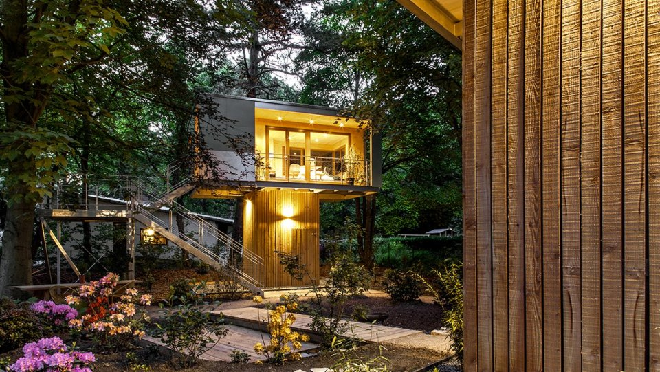 A pair of modern treehouses at the edge of a forest provide leafy retreats complete with kitchenette and bath. | www.facebook.com/SmallHouseBliss