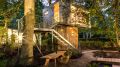 A pair of modern treehouses at the edge of a forest provide leafy retreats complete with kitchenette and bath. | www.facebook.com/SmallHouseBliss