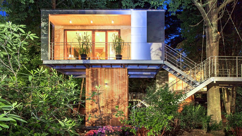 A pair of modern treehouses at the edge of a forest provide leafy retreats complete with kitchenette and bath. | www.facebook.com/SmallHouseBliss