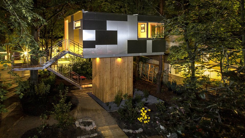 A pair of modern treehouses at the edge of a forest provide leafy retreats complete with kitchenette and bath. | www.facebook.com/SmallHouseBliss