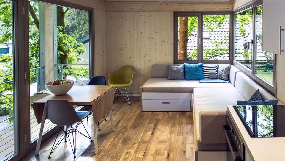 A pair of modern treehouses at the edge of a forest provide leafy retreats complete with kitchenette and bath. | www.facebook.com/SmallHouseBliss