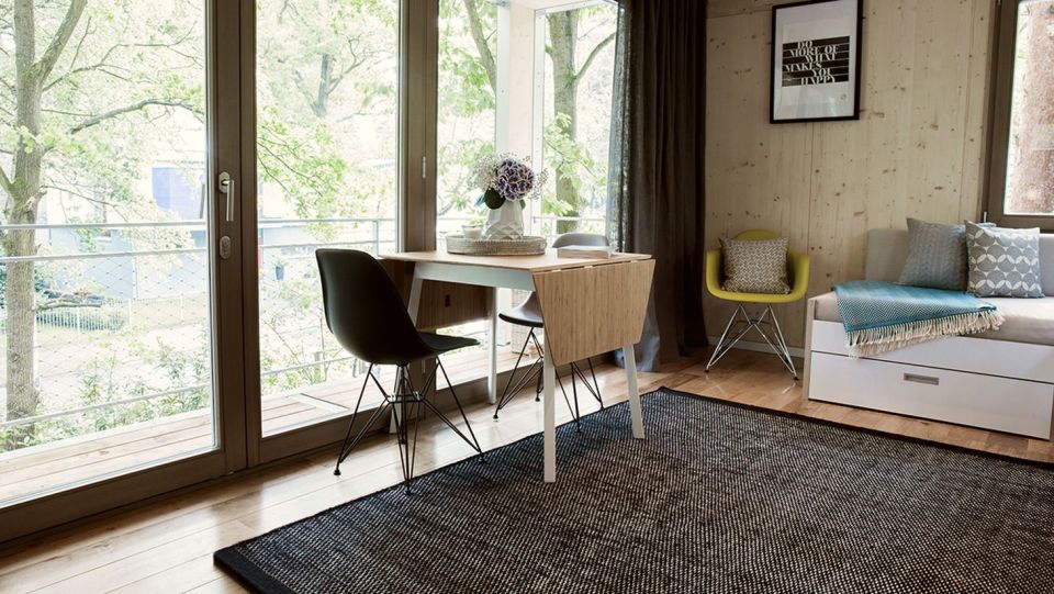 A pair of modern treehouses at the edge of a forest provide leafy retreats complete with kitchenette and bath. | www.facebook.com/SmallHouseBliss