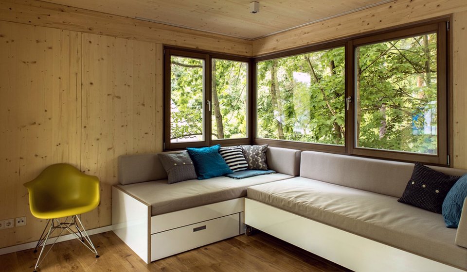 A pair of modern treehouses at the edge of a forest provide leafy retreats complete with kitchenette and bath. | www.facebook.com/SmallHouseBliss