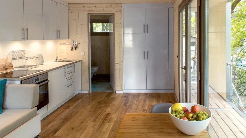 A pair of modern treehouses at the edge of a forest provide leafy retreats complete with kitchenette and bath. | www.facebook.com/SmallHouseBliss