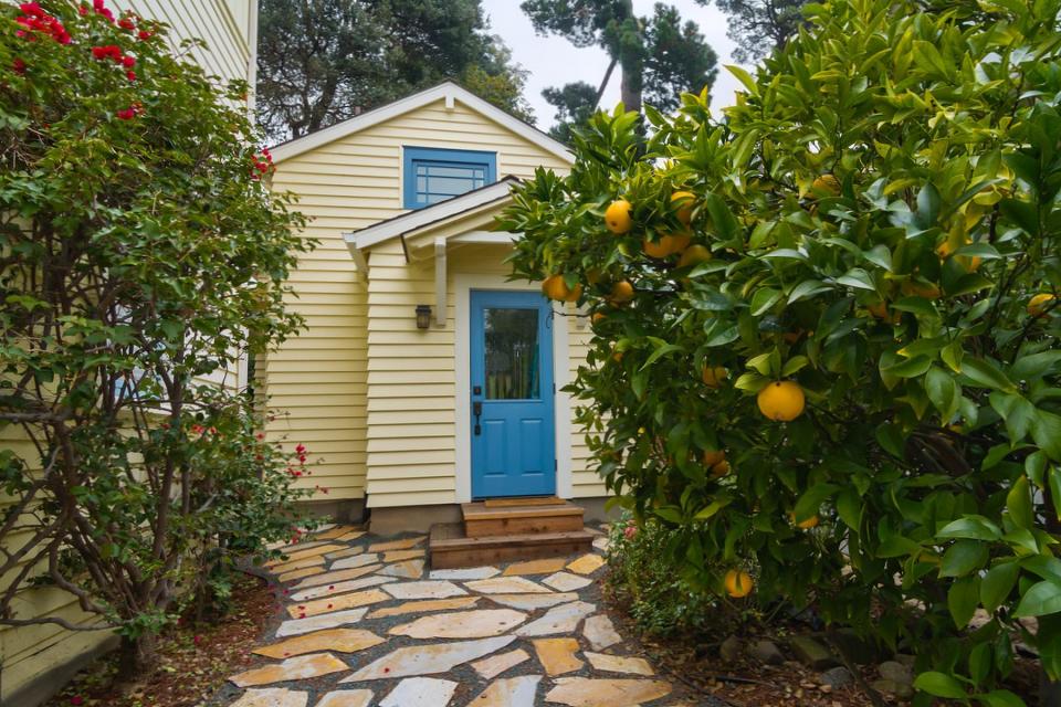 Though just 469 sq ft total, Susan's backyard cottage squeezes in spiral stairs to the loft bedroom. | www.facebook.com/SmallHouseBliss