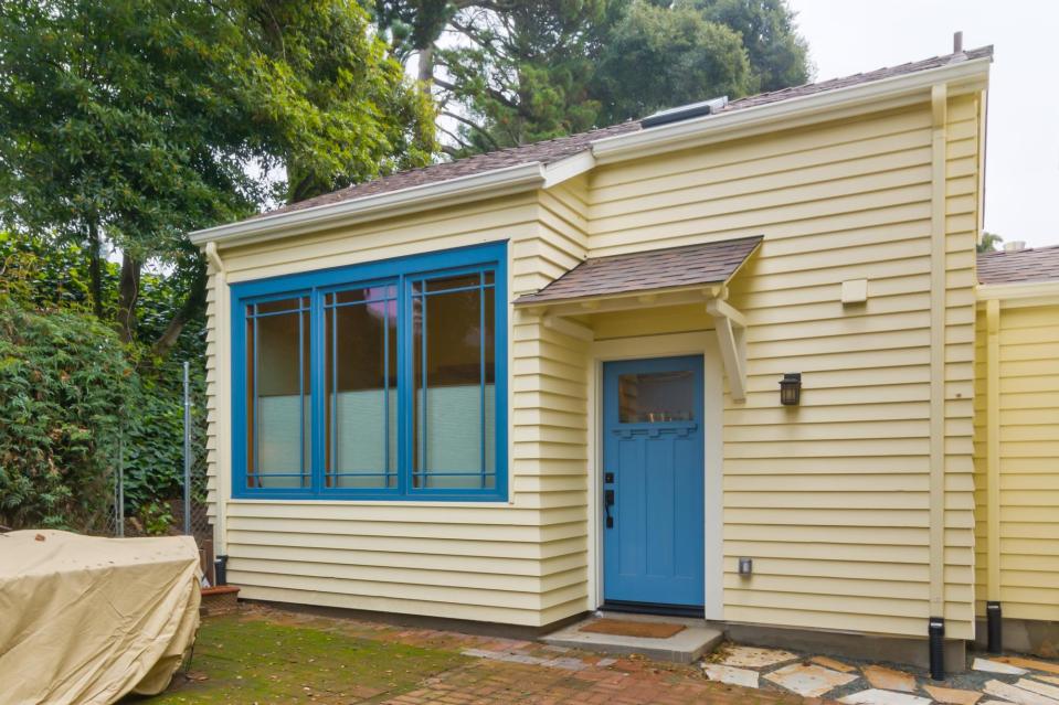 Though just 469 sq ft total, Susan's backyard cottage squeezes in spiral stairs to the loft bedroom. | www.facebook.com/SmallHouseBliss