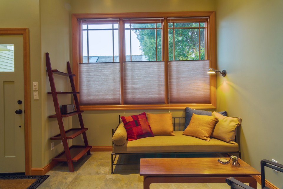 Though just 469 sq ft total, Susan's backyard cottage squeezes in spiral stairs to the loft bedroom. | www.facebook.com/SmallHouseBliss