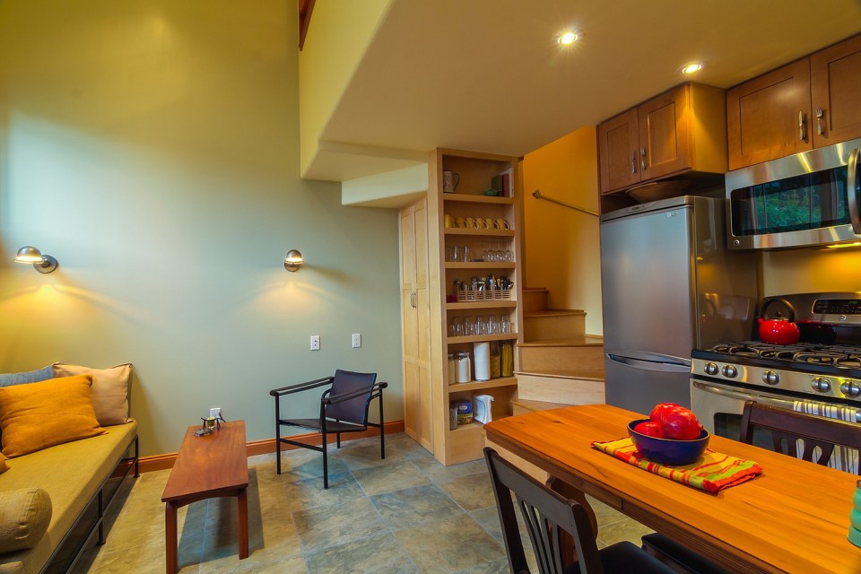 Although just 469 sq ft total, Susan's backyard cottage squeezes in spiral stairs to the loft bedroom. | www.facebook.com/SmallHouseBliss