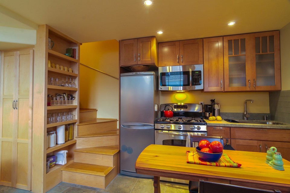 Though just 469 sq ft total, Susan's backyard cottage squeezes in spiral stairs to the loft bedroom. | www.facebook.com/SmallHouseBliss