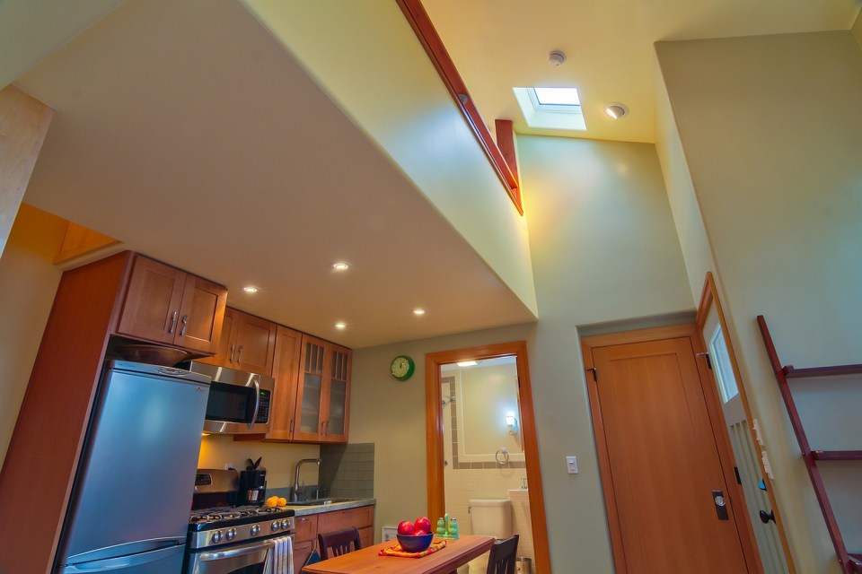 Though just 469 sq ft total, Susan's backyard cottage squeezes in spiral stairs to the loft bedroom. | www.facebook.com/SmallHouseBliss