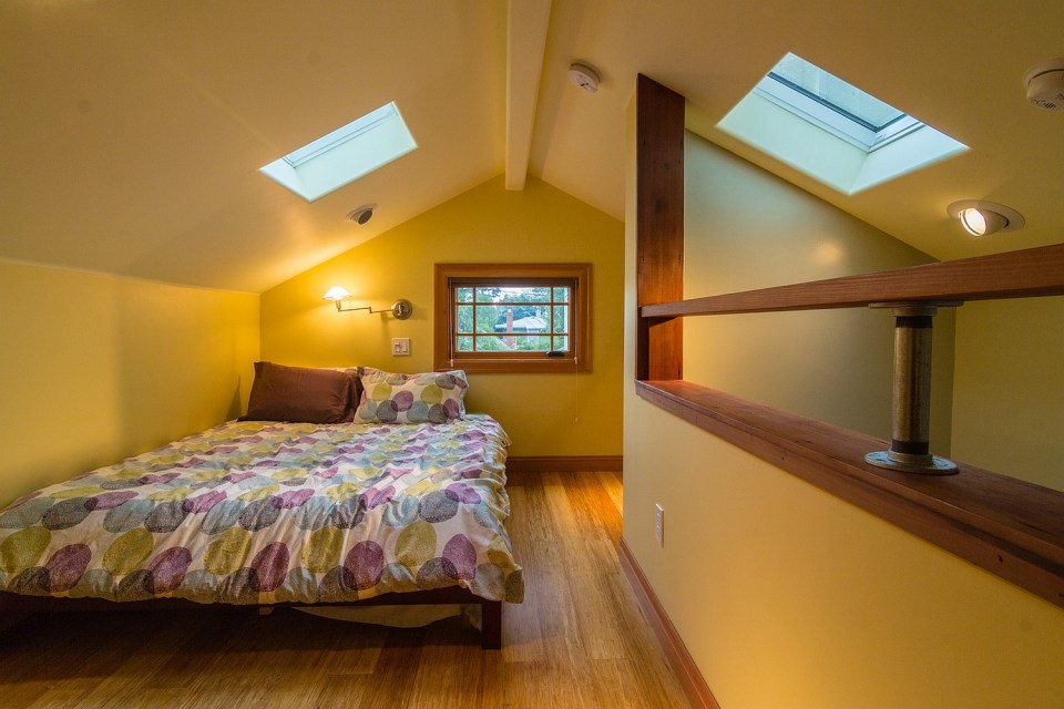 Although just 469 sq ft total, Susan's backyard cottage squeezes in spiral stairs to the loft bedroom. | www.facebook.com/SmallHouseBliss
