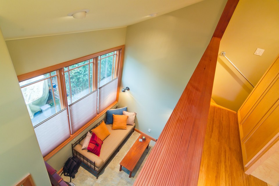 Though just 469 sq ft total, Susan's backyard cottage squeezes in spiral stairs to the loft bedroom. | www.facebook.com/SmallHouseBliss