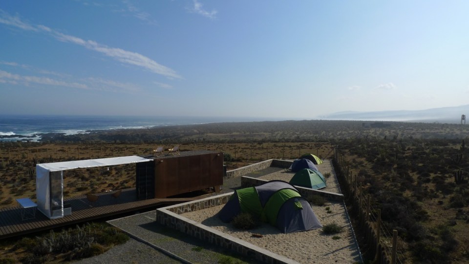 Located near a beach in Chile, this camping compound has a shipping container kitchen/bath, water tower and tent pads. | www.facebook.com/SmallHouseBliss
