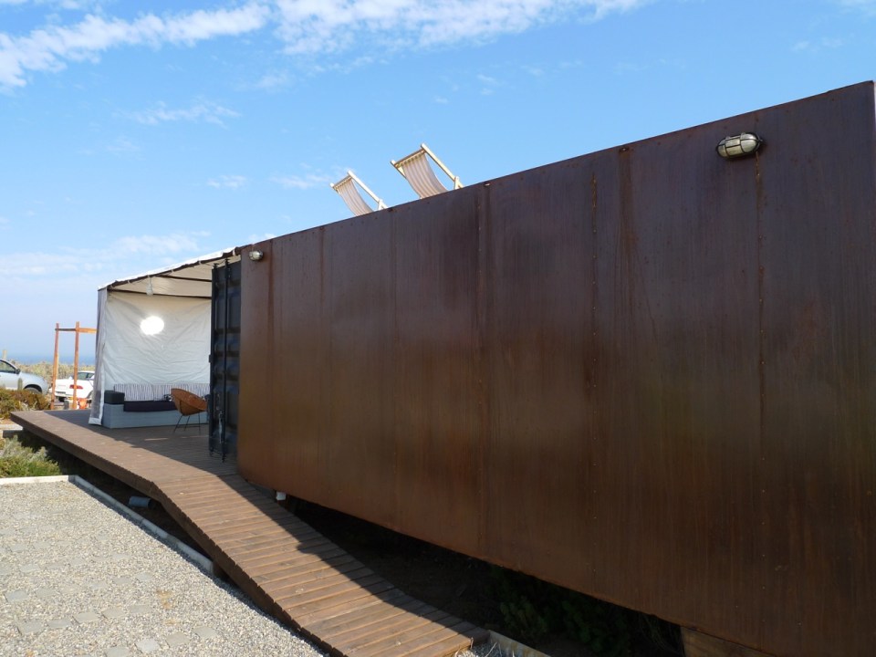 Located near a beach in Chile, this camping compound has a shipping container kitchen/bath, water tower and tent pads. | www.facebook.com/SmallHouseBliss