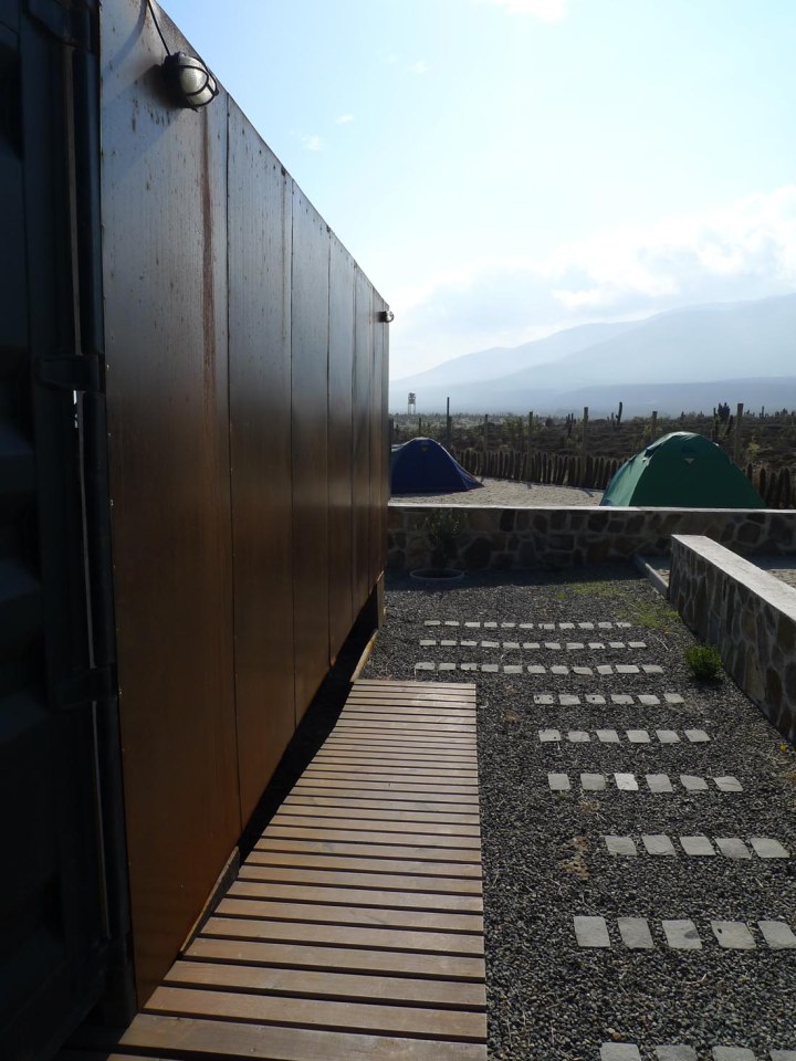 Located near a beach in Chile, this camping compound has a shipping container kitchen/bath, water tower and tent pads. | www.facebook.com/SmallHouseBliss