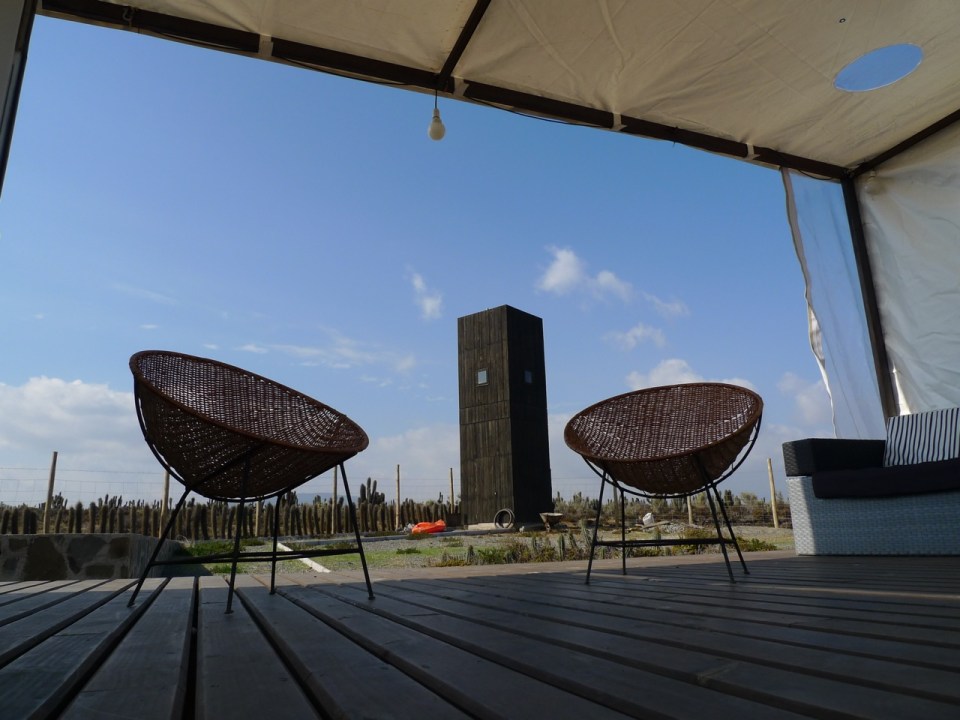 Located near a beach in Chile, this camping compound has a shipping container kitchen/bath, water tower and tent pads. | www.facebook.com/SmallHouseBliss
