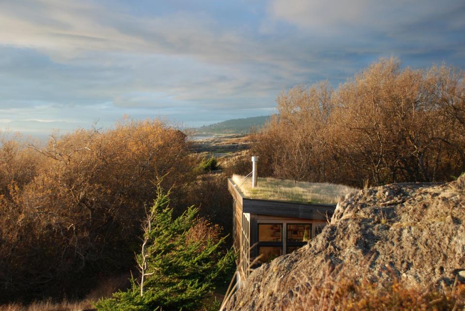 With a sod roof and weathered cedar siding, Eagle Point cabin blends with the San Juan Island landscape. It has 1 bedroom in 688 sq ft. | www.facebook.com/SmallHouseBliss