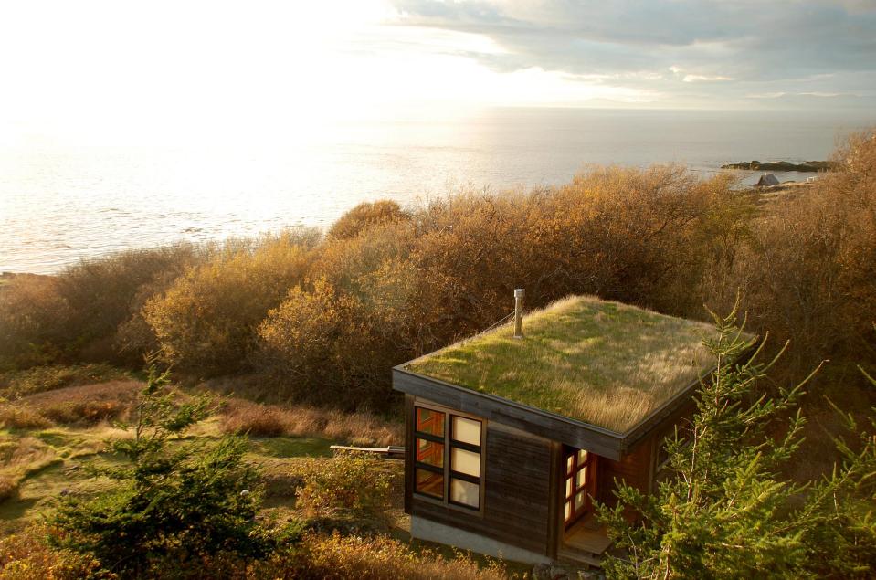 With a sod roof and weathered cedar siding, Eagle Point cabin blends with the San Juan Island landscape. It has 1 bedroom in 688 sq ft. | www.facebook.com/SmallHouseBliss
