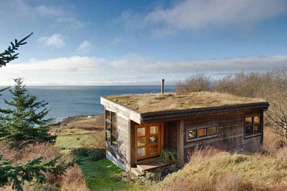 With a sod roof and weathered cedar siding, Eagle Point cabin blends with the San Juan Island landscape. It has 1 bedroom in 688 sq ft. | www.facebook.com/SmallHouseBliss