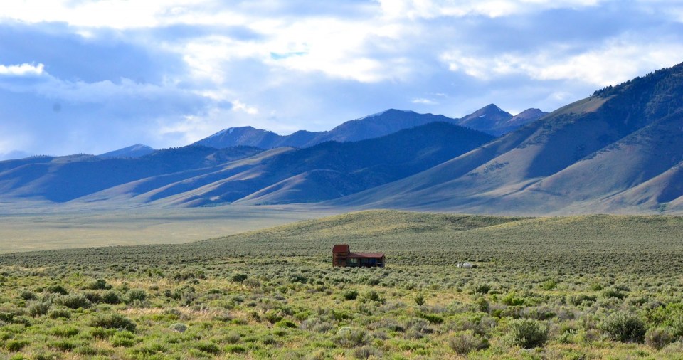Little Lost Cabin, a small square-log cabin on 3,700 acres of Idaho ranchland. The 800 sq ft cabin has an open bedroom and a loft. | www.facebook.com/SmallHouseBliss