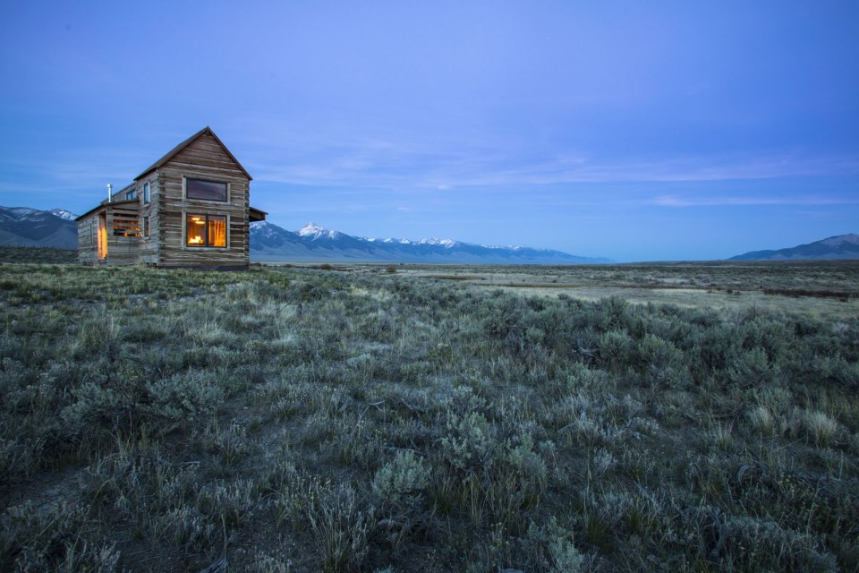 Little Lost Cabin, a small square-log cabin on 3,700 acres of Idaho ranchland. The 800 sq ft cabin has an open bedroom and a loft. | www.facebook.com/SmallHouseBliss