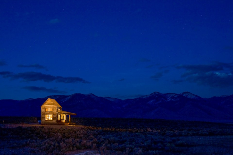 Little Lost Cabin, a small square-log cabin on 3,700 acres of Idaho ranchland. The 800 sq ft cabin has an open bedroom and a loft. | www.facebook.com/SmallHouseBliss