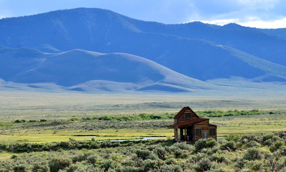 Little Lost Cabin, a small square-log cabin on 3,700 acres of Idaho ranchland. The 800 sq ft cabin has an open bedroom and a loft. | www.facebook.com/SmallHouseBliss