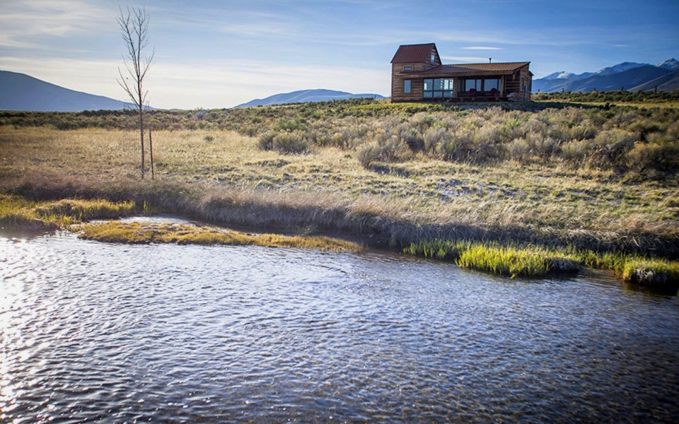 Little Lost Cabin, a small square-log cabin on 3,700 acres of Idaho ranchland. The 800 sq ft cabin has an open bedroom and a loft. | www.facebook.com/SmallHouseBliss