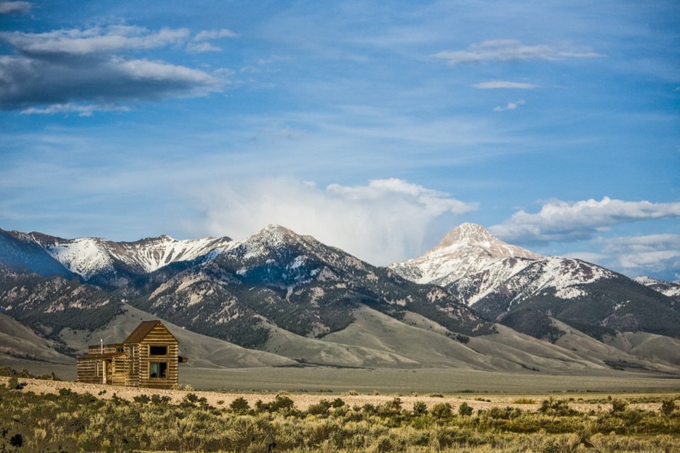 Little Lost Cabin, a small square-log cabin on 3,700 acres of Idaho ranchland. The 800 sq ft cabin has an open bedroom and a loft. | www.facebook.com/SmallHouseBliss