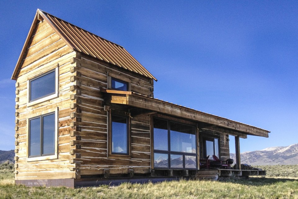 Little Lost Cabin, a small square-log cabin on 3,700 acres of Idaho ranchland. The 800 sq ft cabin has an open bedroom and a loft. | www.facebook.com/SmallHouseBliss