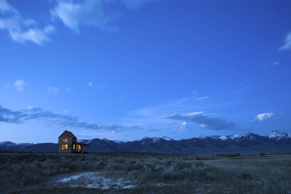 Little Lost Cabin, a small square-log cabin on 3,700 acres of Idaho ranchland. The 800 sq ft cabin has an open bedroom and a loft. | www.facebook.com/SmallHouseBliss