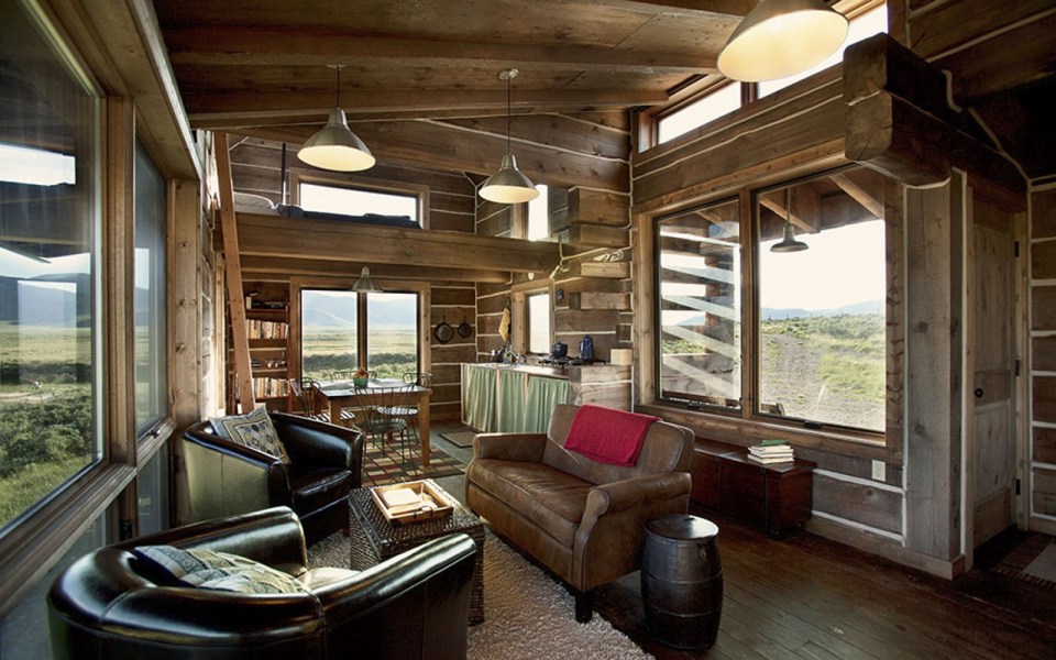 Little Lost Cabin, a small square-log cabin on 3,700 acres of Idaho ranchland. The 800 sq ft cabin has an open bedroom and a loft. | www.facebook.com/SmallHouseBliss