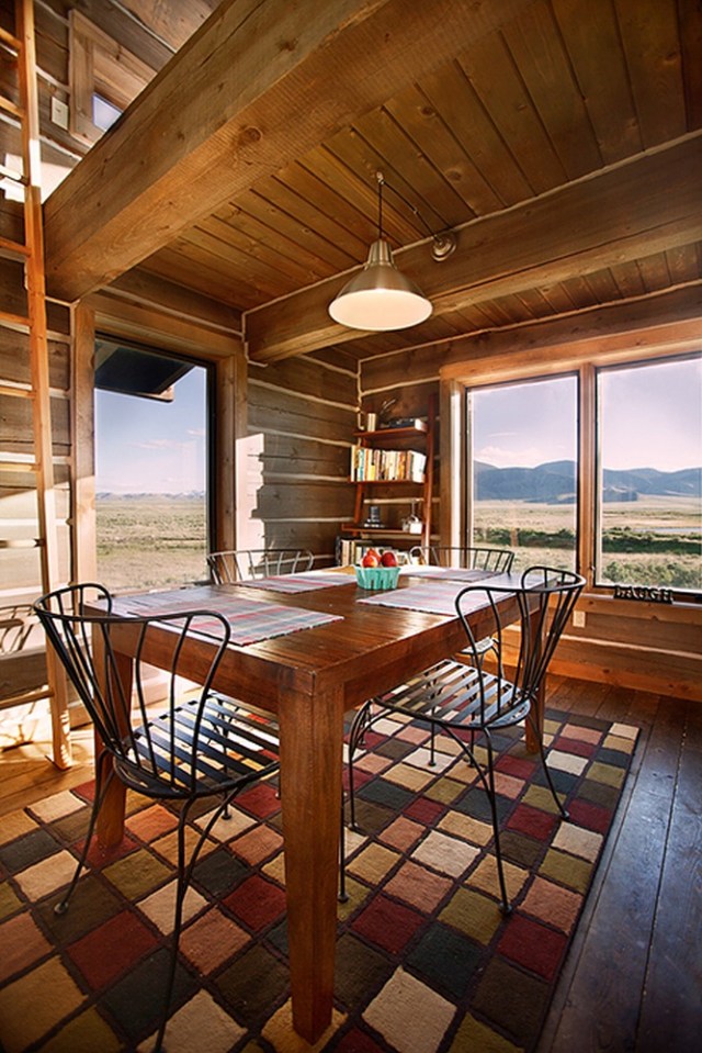 Little Lost Cabin, a small square-log cabin on 3,700 acres of Idaho ranchland. The 800 sq ft cabin has an open bedroom and a loft. | www.facebook.com/SmallHouseBliss