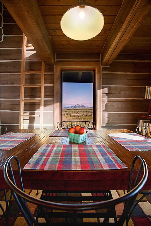 Little Lost Cabin, a small square-log cabin on 3,700 acres of Idaho ranchland. The 800 sq ft cabin has an open bedroom and a loft. | www.facebook.com/SmallHouseBliss