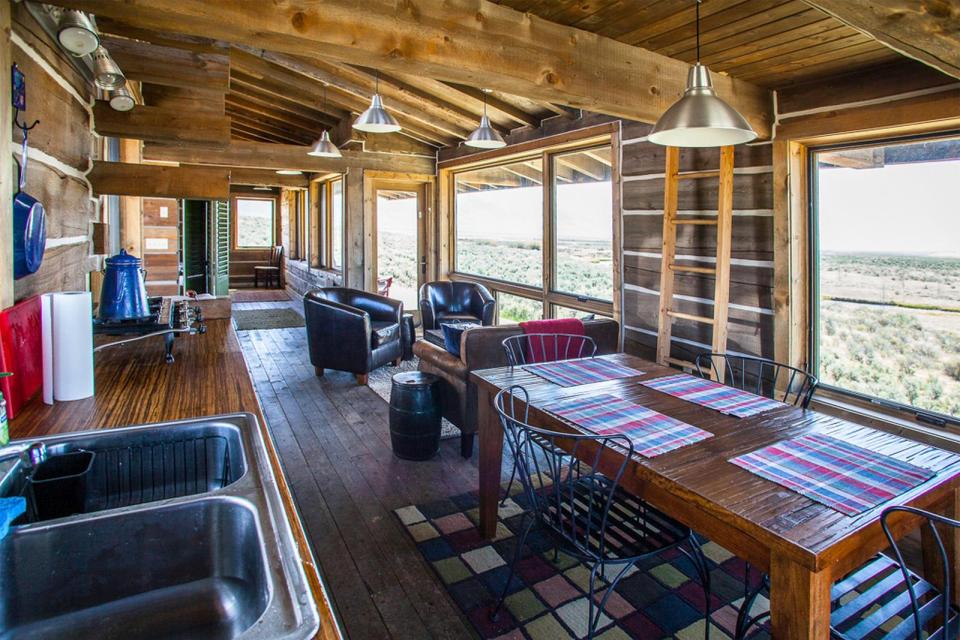 Little Lost Cabin, a small square-log cabin on 3,700 acres of Idaho ranchland. The 800 sq ft cabin has an open bedroom and a loft. | www.facebook.com/SmallHouseBliss