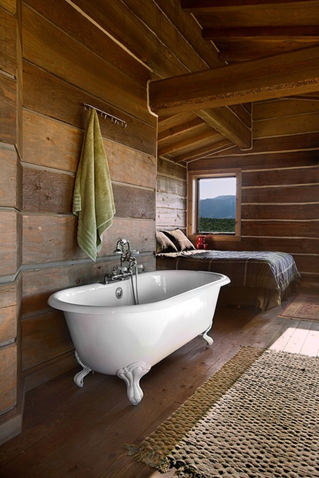 Little Lost Cabin, a small square-log cabin on 3,700 acres of Idaho ranchland. The 800 sq ft cabin has an open bedroom and a loft. | www.facebook.com/SmallHouseBliss