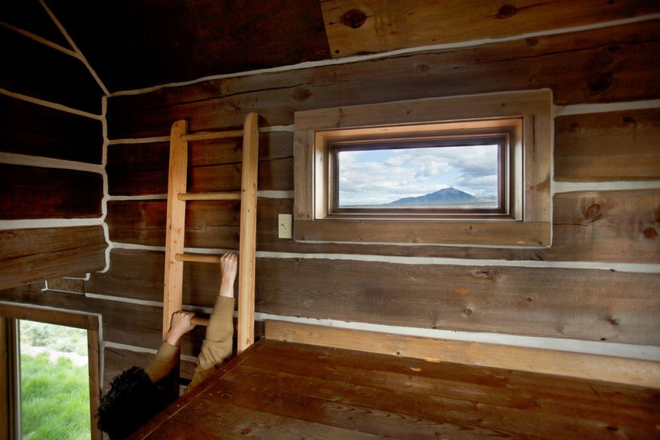 Little Lost Cabin, a small square-log cabin on 3,700 acres of Idaho ranchland. The 800 sq ft cabin has an open bedroom and a loft. | www.facebook.com/SmallHouseBliss