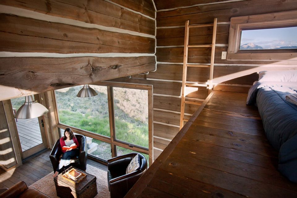 Little Lost Cabin, a small square-log cabin on 3,700 acres of Idaho ranchland. The 800 sq ft cabin has an open bedroom and a loft. | www.facebook.com/SmallHouseBliss