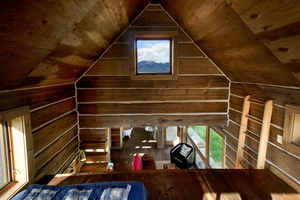 Little Lost Cabin, a small square-log cabin on 3,700 acres of Idaho ranchland. The 800 sq ft cabin has an open bedroom and a loft. | www.facebook.com/SmallHouseBliss