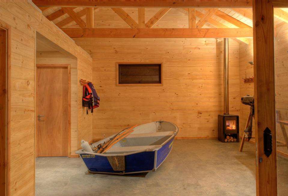 "Casa Bote" is a dual-use structure, serving as a cabin in the summer and a boat storage shed over the winter. | www.facebook.com/SmallHouseBliss