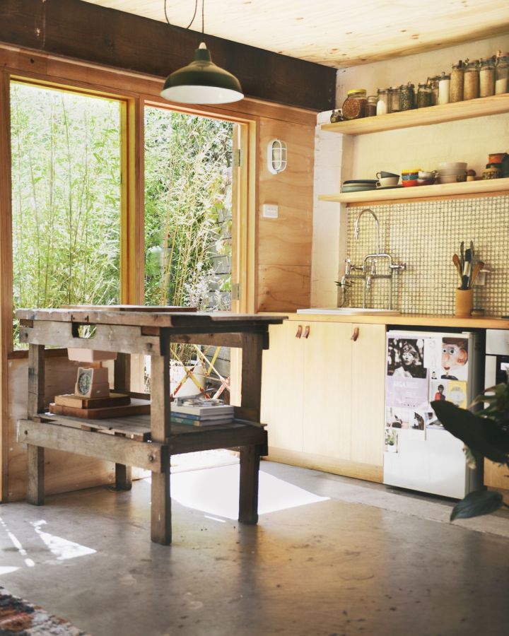 A detached two-car garage was transformed into this bright and airy backyard cottage with a studio floor plan. | www.facebook.com/SmallHouseBliss